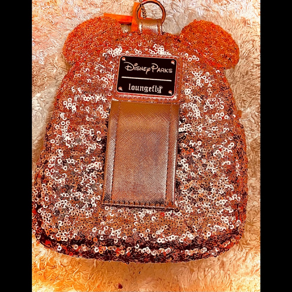 It’s a rose gold shimmery mini Disney World book bag